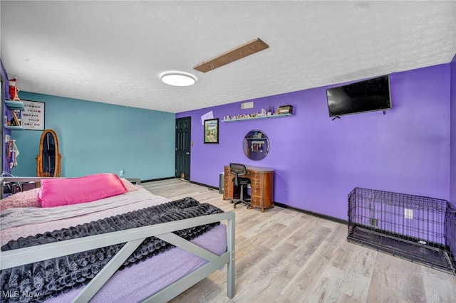 bedroom featuring hardwood / wood-style floors and a textured ceiling