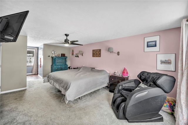 carpeted bedroom with a textured ceiling and ceiling fan