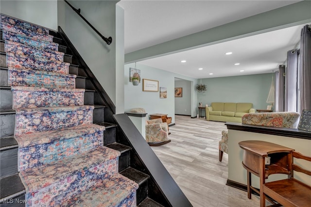 stairs featuring hardwood / wood-style floors