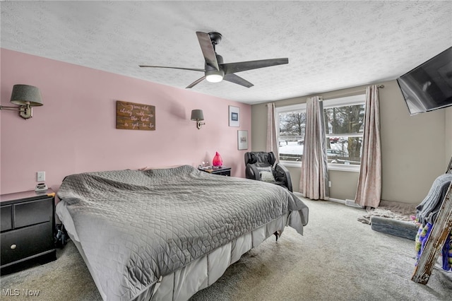 carpeted bedroom with ceiling fan and a textured ceiling