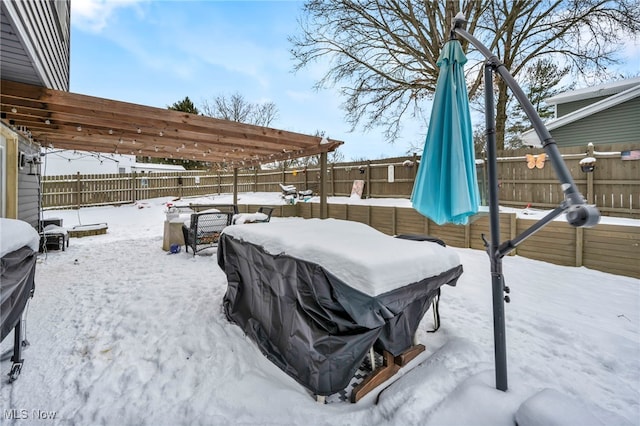 yard covered in snow featuring a pergola