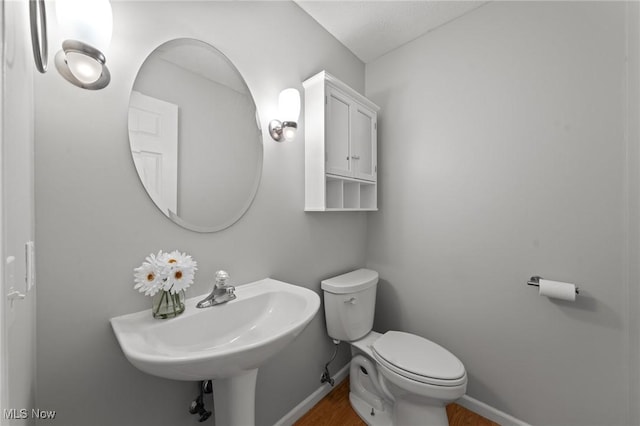 bathroom featuring toilet and sink