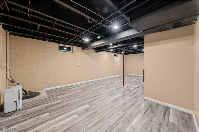 basement with hardwood / wood-style flooring