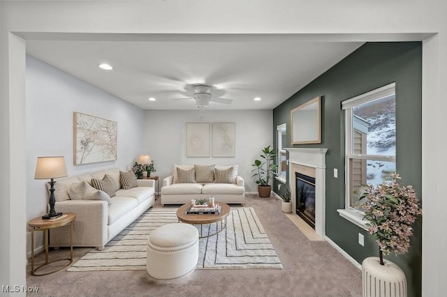 living room with ceiling fan and light colored carpet