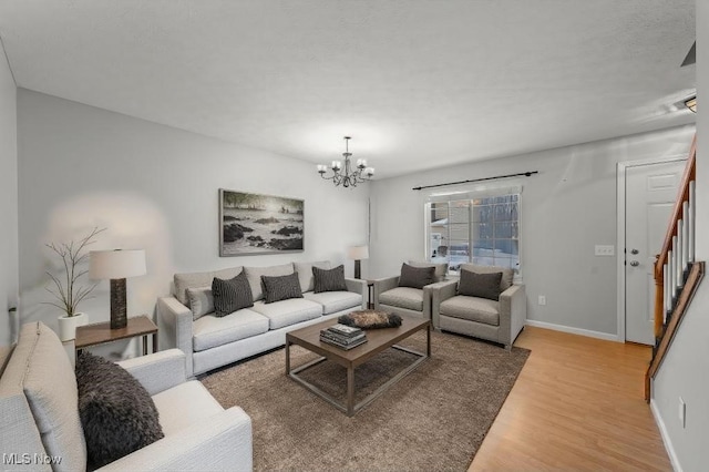 living room with a chandelier and wood-type flooring