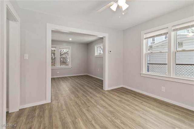 empty room featuring ceiling fan and light hardwood / wood-style flooring