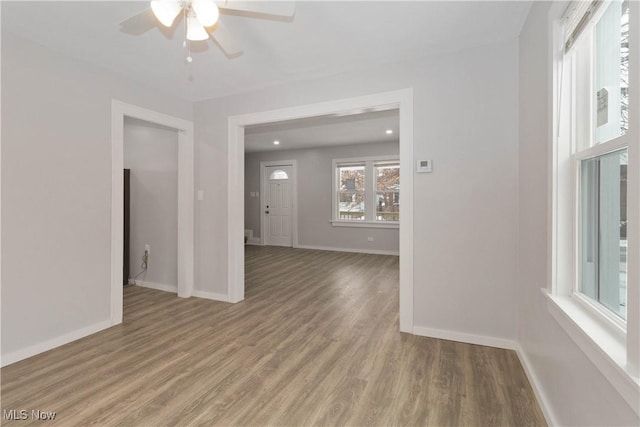 empty room with ceiling fan and wood-type flooring