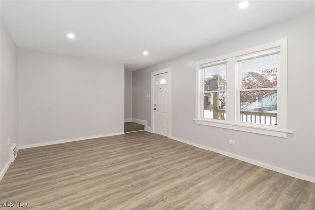 empty room with hardwood / wood-style floors