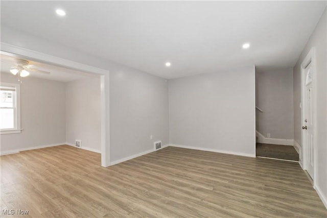 empty room with ceiling fan and hardwood / wood-style floors