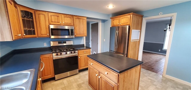 kitchen with a center island, stainless steel appliances, and sink