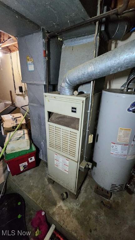 utility room featuring water heater