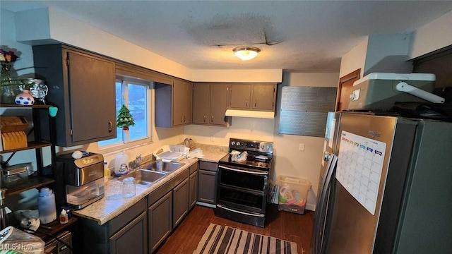 kitchen featuring black electric range oven, sink, a textured ceiling, dark hardwood / wood-style flooring, and stainless steel refrigerator