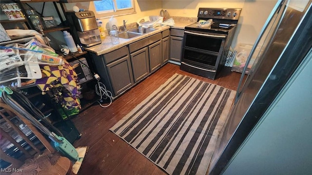 kitchen featuring stainless steel appliances, dark hardwood / wood-style floors, and sink