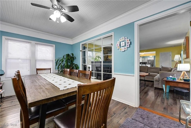 dining space featuring dark hardwood / wood-style floors, ceiling fan, and crown molding