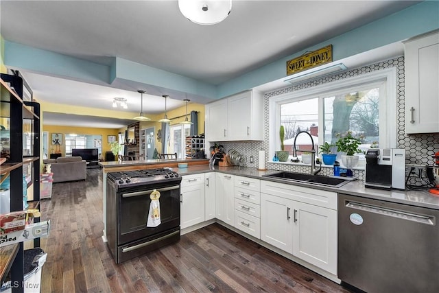 kitchen with white cabinets, sink, decorative light fixtures, kitchen peninsula, and stainless steel appliances