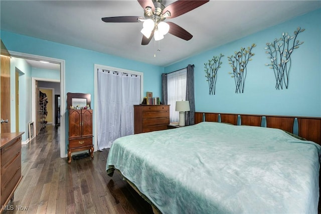 bedroom with ceiling fan and dark wood-type flooring