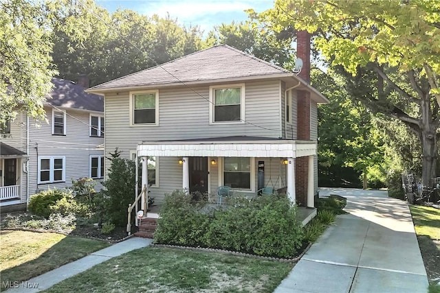 view of front of home featuring a porch and a front lawn