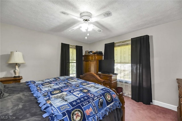 carpeted bedroom with a textured ceiling and ceiling fan