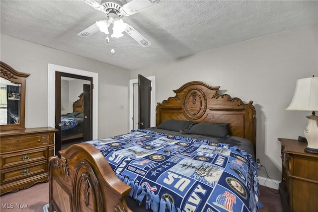 bedroom featuring ceiling fan, carpet, and a textured ceiling