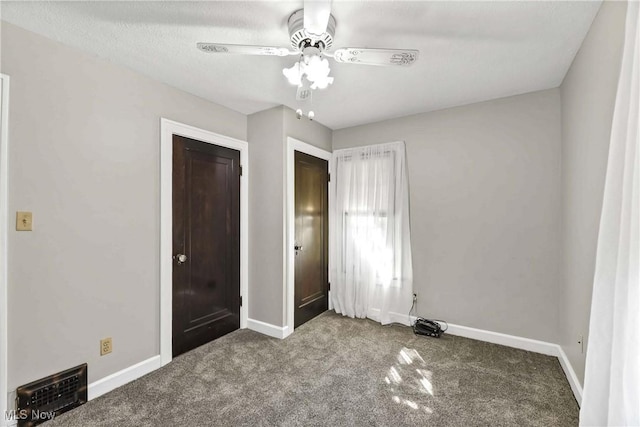 unfurnished bedroom with ceiling fan, a closet, carpet floors, and a textured ceiling