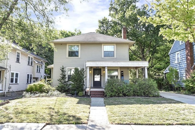 view of front facade featuring a front lawn and covered porch