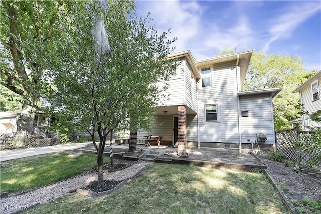 rear view of house with a lawn