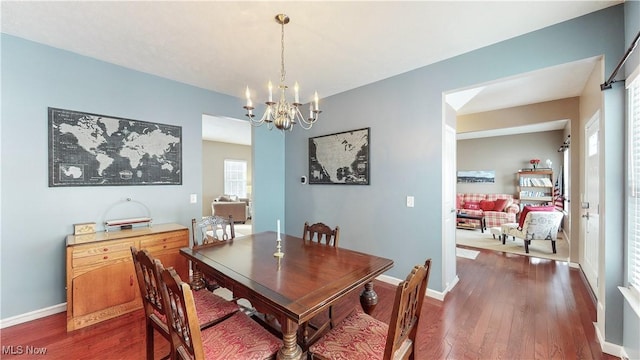 dining room featuring dark hardwood / wood-style floors and a notable chandelier