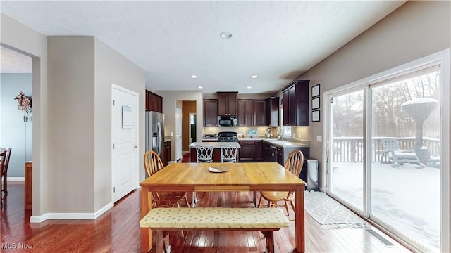 dining room with sink and dark wood-type flooring