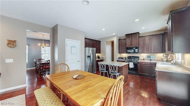 dining room with a chandelier, dark hardwood / wood-style floors, and sink