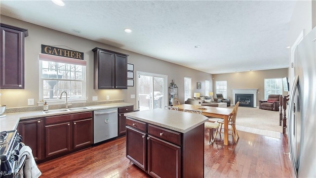 kitchen featuring a textured ceiling, a center island, dark hardwood / wood-style flooring, and stainless steel appliances