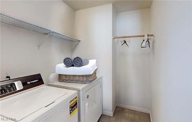 clothes washing area featuring independent washer and dryer