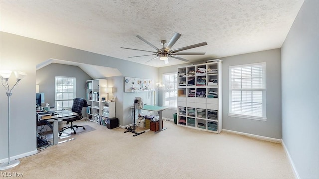 carpeted office space featuring ceiling fan, lofted ceiling, and a textured ceiling