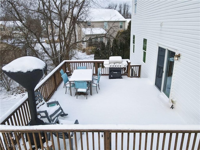 snow covered deck featuring grilling area