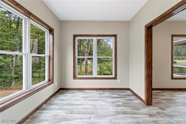 unfurnished room featuring plenty of natural light