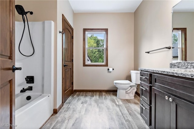 full bathroom with hardwood / wood-style floors, vanity, toilet, and a wealth of natural light