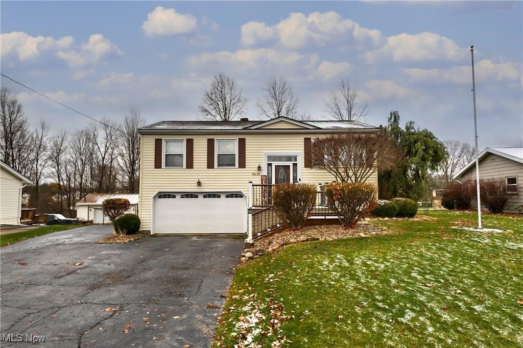 view of front of house with a front yard and a garage