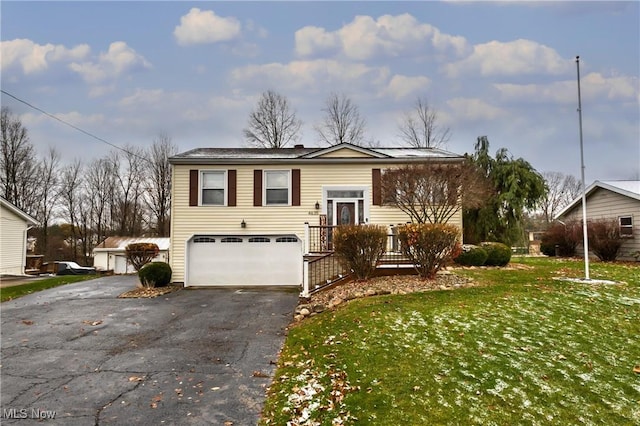 view of front of house with a front yard and a garage