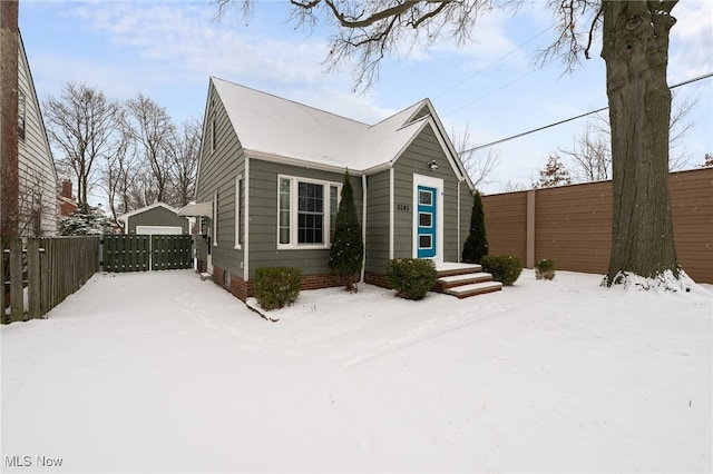 view of front of property featuring a garage and an outbuilding