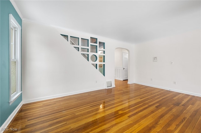 spare room featuring hardwood / wood-style floors and ornamental molding