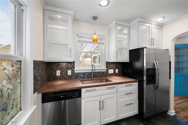 kitchen featuring backsplash, white cabinets, sink, dark hardwood / wood-style floors, and appliances with stainless steel finishes