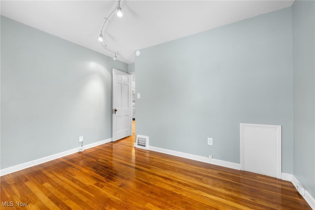 unfurnished room with hardwood / wood-style flooring