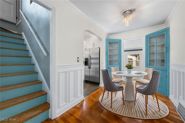 dining room with ornamental molding and dark wood-type flooring