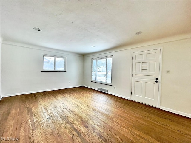 spare room with wood-type flooring