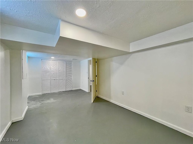 basement featuring a textured ceiling