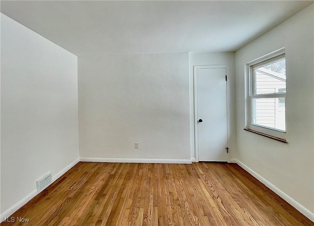 spare room with light hardwood / wood-style floors