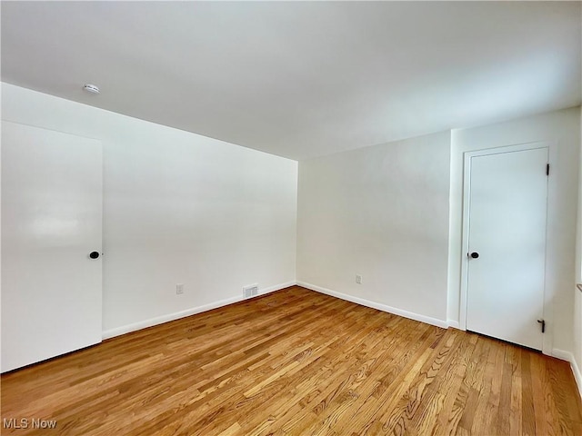 spare room featuring light hardwood / wood-style floors