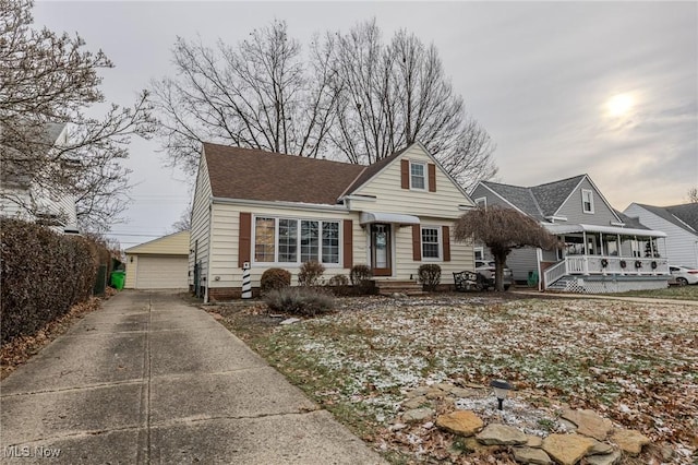 view of front of home with a garage and an outdoor structure