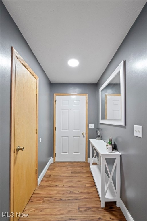 doorway with light wood-type flooring