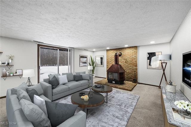 carpeted living room featuring a wood stove and a textured ceiling