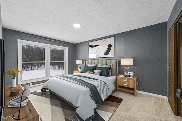 bedroom featuring carpet floors and a textured ceiling